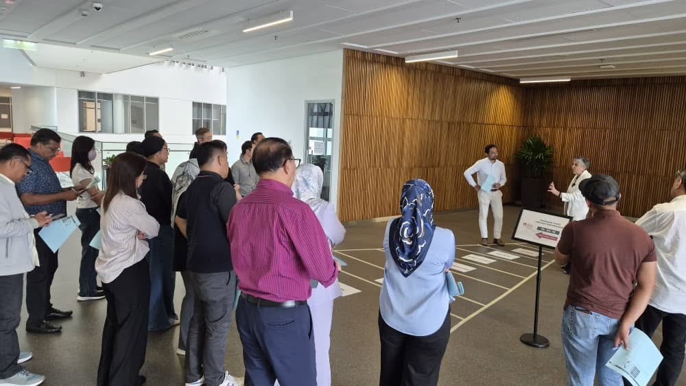 A group of 25 corporate participants posing with Human Equation founder Sheila Singam during an Asia School of Business workshop on building high-performing teams.